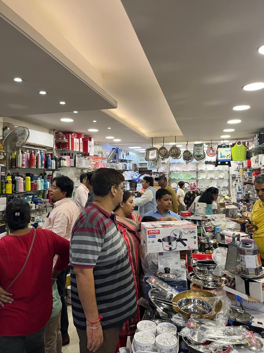 Busy store aisle with bottles and crockery
